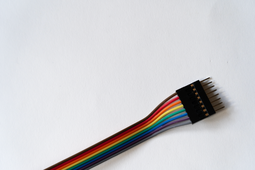 The picture is a photo showing a rainbowcoloured electronical cable.